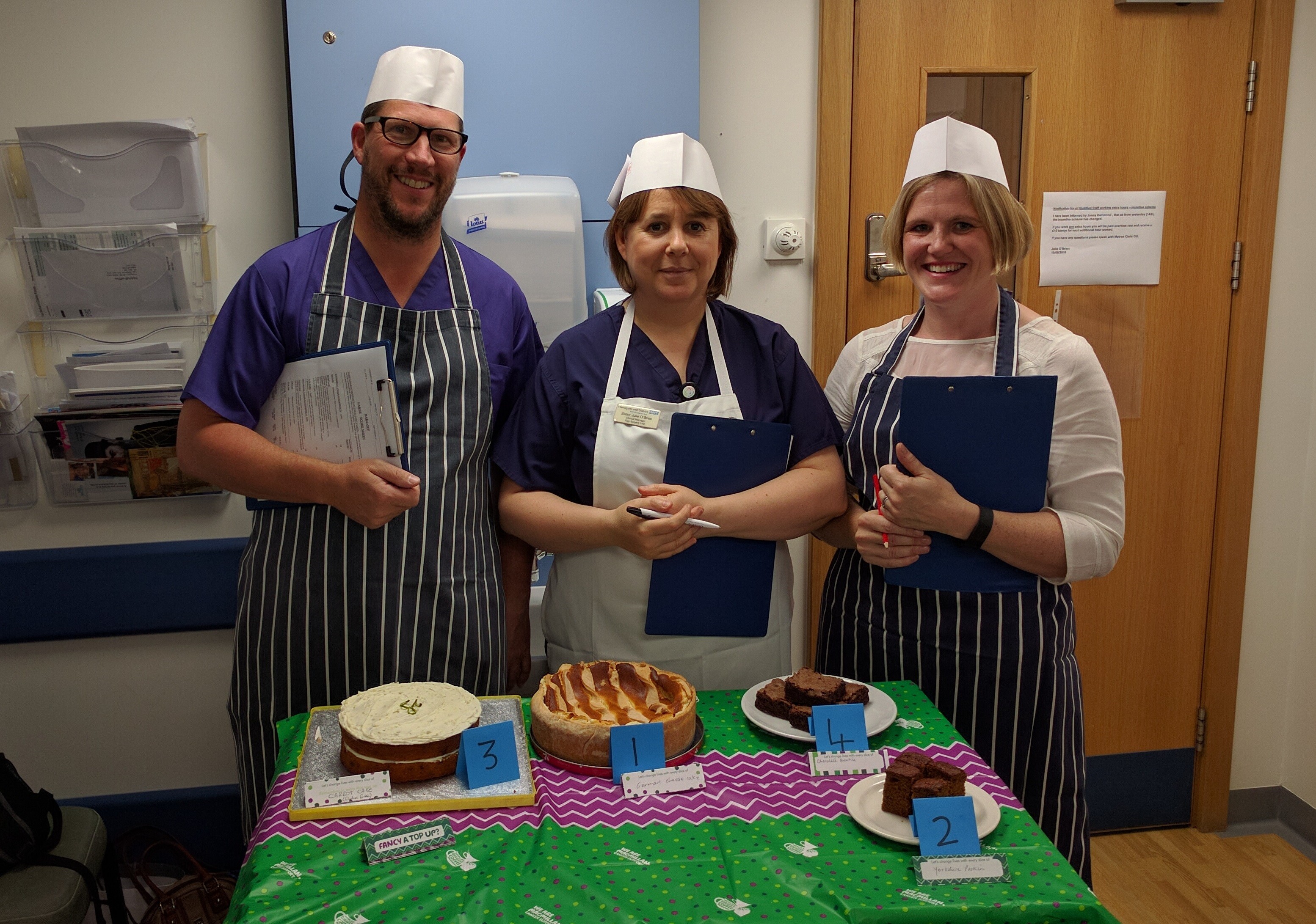 Sampling the delights - Staff play the part of Bake Off judges in best cake competition.