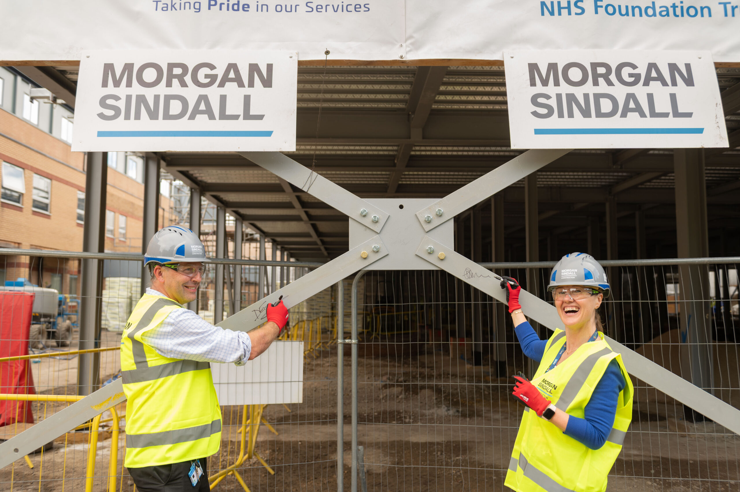 David Earl, Deputy Medical Director at HDFT and Sarah Armstrong, Chair of HDFT take part in steel signing