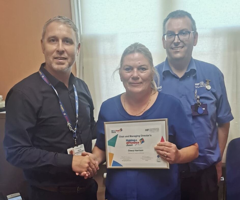 HDFT’s Making a Difference winner with colleagues receiving the award presented by a Trust Executive.