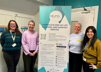 Team members in front of HELPSS banner